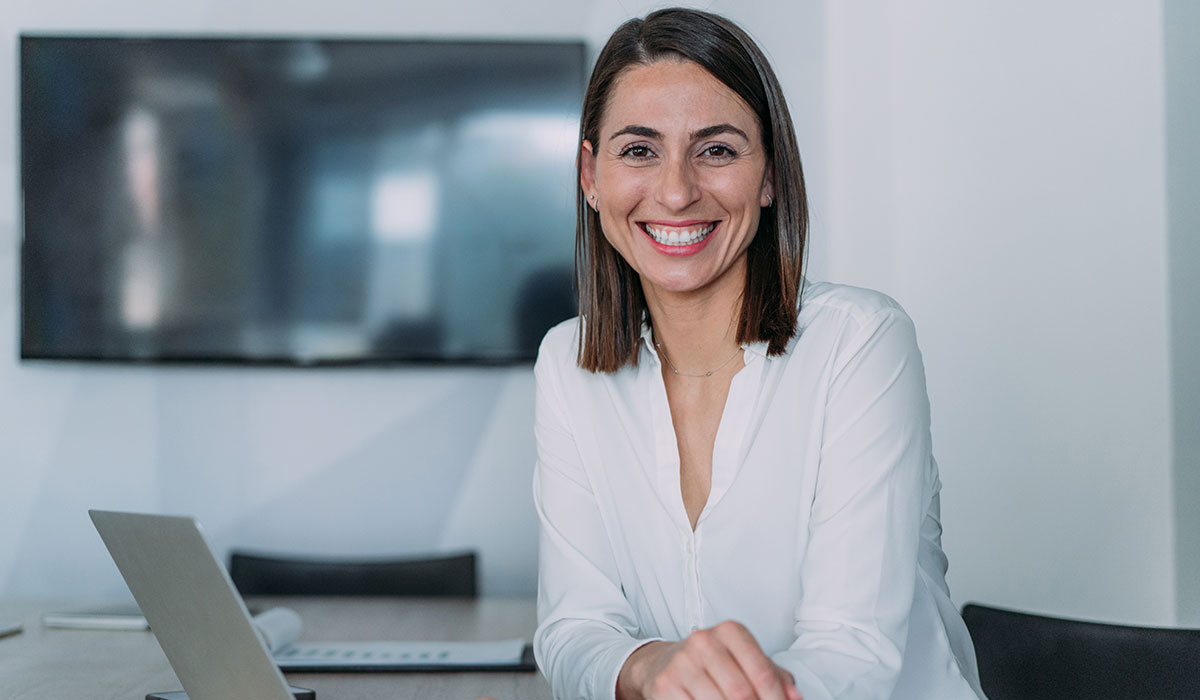 business woman smiling at desk